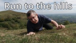 Man crawling up a hillside